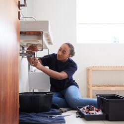 Local plumber repairing a sink